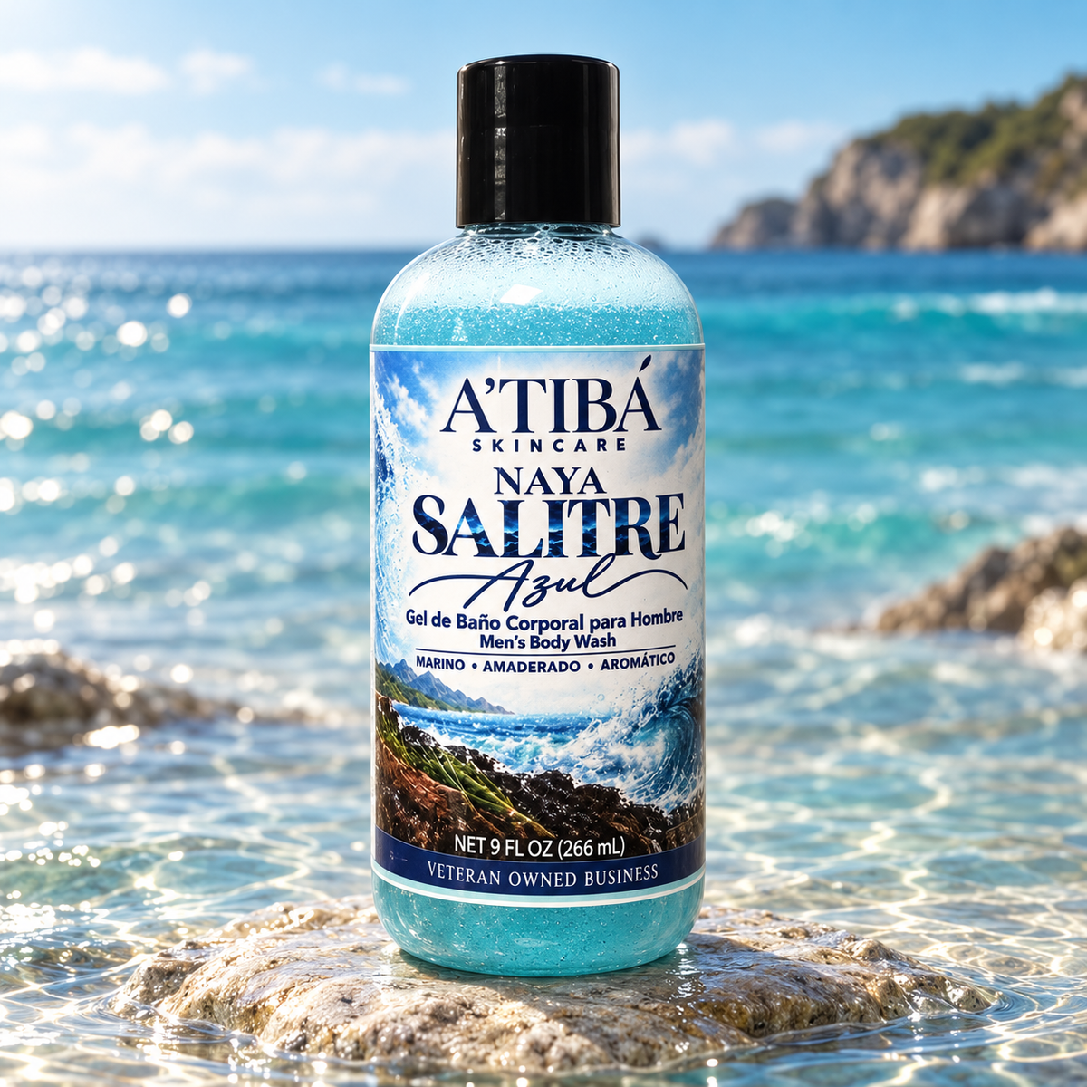NAYA Salitre Azul hero product shot — clear 9 oz bottle with deep ocean-blue gel standing upright on submerged coastal rock with turquoise water background, Marino Amaderado Aromático, A'TIBÁ Skincare Puerto Rico