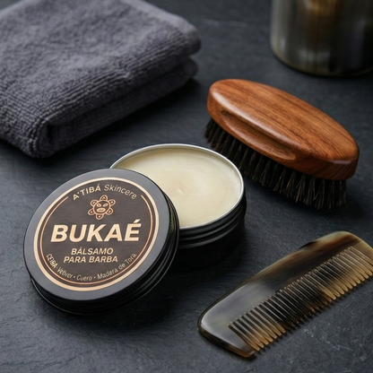 Open Bukaé beard balm tin showing balm texture beside beard brush and comb.